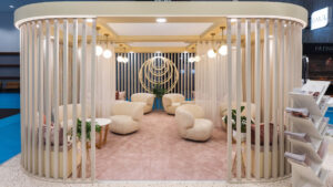 salon réception d'un stand avec fauteuils beige et claustra